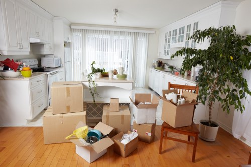 Professional movers carrying furniture during a local Harringay relocation